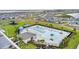 An aerial view of a resort style community pool with palm trees and lounge chairs at 2027 Airedale Way, Lake Alfred, FL 33850