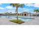 Beautiful community pool area featuring clear blue water, palm trees, and ample seating at 2027 Airedale Way, Lake Alfred, FL 33850