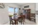 Cozy dining area with sliding glass doors leading to the backyard and a classic wooden cabinet at 2027 Airedale Way, Lake Alfred, FL 33850