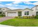 Beautifully landscaped single-story house, featuring a well-manicured lawn, brick driveway and a two-car garage at 2027 Airedale Way, Lake Alfred, FL 33850