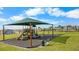 Community playground with slides, swings, and a protective canopy at 2027 Airedale Way, Lake Alfred, FL 33850