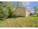 Exterior of home featuring a grassy backyard, and access door on a sunny day at 2161 Maple Hill Ct, Lakeland, FL 33811