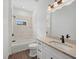 Beautiful bathroom featuring marble tiling, granite countertop, and shower with tub at 2161 Maple Hill Ct, Lakeland, FL 33811