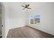 Bedroom features wood-look floors, ceiling fan and large window at 2161 Maple Hill Ct, Lakeland, FL 33811