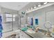 Bright bathroom featuring a shower with glass doors, a large mirror, and a stylish countertop at 2173 Mission Hills Dr, Lakeland, FL 33810