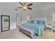 Spacious bedroom with a large window and stylish patterned bedding and an ottoman for storage at 2173 Mission Hills Dr, Lakeland, FL 33810