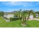 Charming single-story home with beautiful landscaping, healthy green lawn, and mature palm trees at 2173 Mission Hills Dr, Lakeland, FL 33810