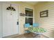 Charming front porch with seating, a welcome sign and a decorative door at 2173 Mission Hills Dr, Lakeland, FL 33810