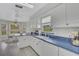 Well-lit kitchen featuring white cabinets, a bay window, and a tile backsplash at 2173 Mission Hills Dr, Lakeland, FL 33810