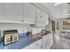 Well-equipped kitchen featuring white appliances, plenty of cabinet space, and a modern countertop at 2173 Mission Hills Dr, Lakeland, FL 33810