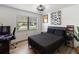 This bedroom features a sleek black color scheme, hardwood floors, and plenty of natural light at 2326 Eastmeadows Rd, Lakeland, FL 33812