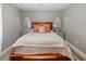 Cozy bedroom with a wood headboard bed, decorative pillows, mirrored end tables, and neutral walls at 2326 Eastmeadows Rd, Lakeland, FL 33812