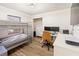 Neutral room with a bunk bed and closet; featuring a desk with dual monitors and wood-look flooring at 2326 Eastmeadows Rd, Lakeland, FL 33812