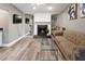 Living room with a mirrored accent wall, a fireplace and light-colored laminate flooring at 2326 Eastmeadows Rd, Lakeland, FL 33812