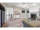 Open living space showcasing the wet bar, fireplace, laminate wood floors and neutral colored walls at 2326 Eastmeadows Rd, Lakeland, FL 33812