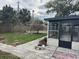 Backyard view with a paved walkway to a screened in porch at 2521 Coral Way, Lakeland, FL 33801