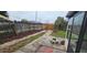 Backyard view featuring a paved walkway, wooden fence, and screened-in porch at 2521 Coral Way, Lakeland, FL 33801
