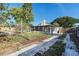 Spacious backyard with a screened porch addition and a paved walkway at 2521 Coral Way, Lakeland, FL 33801