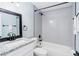 Bathroom featuring tiled shower-tub combo, granite-topped vanity and modern fixtures at 2521 Coral Way, Lakeland, FL 33801