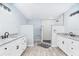 Large bathroom with double granite vanities and walk in shower featuring subway tiles at 2521 Coral Way, Lakeland, FL 33801