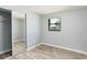 Cozy bedroom with wood-look flooring, a closet with sliding doors, and natural light from window at 2521 Coral Way, Lakeland, FL 33801