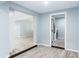 Hallway featuring laminate flooring, neutral walls, and views into other rooms creating depth and connectivity at 2521 Coral Way, Lakeland, FL 33801