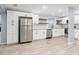 Spacious kitchen boasts white cabinets, stainless steel appliances, granite countertops and laminate flooring at 2521 Coral Way, Lakeland, FL 33801