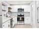Modern kitchen showcases stainless steel appliances, granite countertops, and white cabinets with black hardware at 2521 Coral Way, Lakeland, FL 33801
