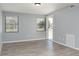 Bright living room features two windows, neutral walls, and durable laminate flooring creating a modern aesthetic at 2521 Coral Way, Lakeland, FL 33801