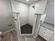 Corner shower enclosure with subway tile walls, granite trim, and black fixtures at 2521 Coral Way, Lakeland, FL 33801