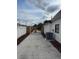 Driveway extends to the backyard with AC unit and mulch bed at 2521 Coral Way, Lakeland, FL 33801