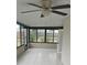 Enclosed sunroom with ceiling fan and tiled floors overlooking the backyard at 2521 Coral Way, Lakeland, FL 33801