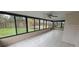Enclosed sunroom featuring ample windows and tile flooring at 2521 Coral Way, Lakeland, FL 33801