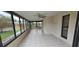 This is an enclosed sunroom featuring ample windows and tiled floors at 2521 Coral Way, Lakeland, FL 33801