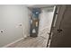 Utility room with gray walls, wood-look floors, and water heater at 2521 Coral Way, Lakeland, FL 33801