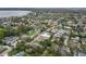 Expansive aerial view of a neighborhood showcasing lush greenery and a serene lake in the background at 2616 Fairmount Ave, Lakeland, FL 33803