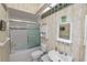 This bathroom features patterned wallpaper, a vanity and a tub with sliding glass doors at 2616 Fairmount Ave, Lakeland, FL 33803