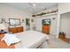 Bright bedroom featuring a ceiling fan, ensuite bathroom, and dresser with decorative mirror at 2616 Fairmount Ave, Lakeland, FL 33803