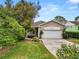 Inviting home with a manicured lawn and mature trees, providing a serene setting at 2616 Fairmount Ave, Lakeland, FL 33803