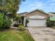 Charming single-story home featuring a stucco exterior, well-manicured lawn, and an attached two-car garage at 2616 Fairmount Ave, Lakeland, FL 33803