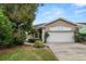 Beautiful single-Gathering home featuring a lush green lawn and mature landscaping for added curb appeal at 2616 Fairmount Ave, Lakeland, FL 33803