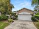 Charming home featuring a two-car garage, well-kept lawn, and lovely landscaping at 2616 Fairmount Ave, Lakeland, FL 33803