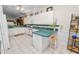 Bright kitchen features white cabinetry and countertops with a breakfast bar and casual seating at 2616 Fairmount Ave, Lakeland, FL 33803