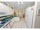 Bright kitchen features white cabinetry, tile floors, and a breakfast nook with lots of natural light at 2616 Fairmount Ave, Lakeland, FL 33803