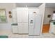 Bright kitchen features white cabinetry and pantry storage along with a side-by-side refrigerator at 2616 Fairmount Ave, Lakeland, FL 33803