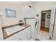 This laundry room features white cabinets, neutral countertops, and a front load washer and dryer at 2616 Fairmount Ave, Lakeland, FL 33803