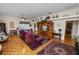 Spacious living room with hardwood flooring, ceiling fan, and two plush arm chairs at 2616 Fairmount Ave, Lakeland, FL 33803