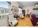 Cozy living room featuring floral armchairs and an art-adorned desk by the window at 2616 Fairmount Ave, Lakeland, FL 33803