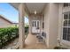 Inviting front porch with brick flooring, white pillars, and a cozy seating area at 2616 Fairmount Ave, Lakeland, FL 33803