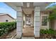 Inviting front porch with brick flooring, white pillars, and a cozy seating area at 2616 Fairmount Ave, Lakeland, FL 33803